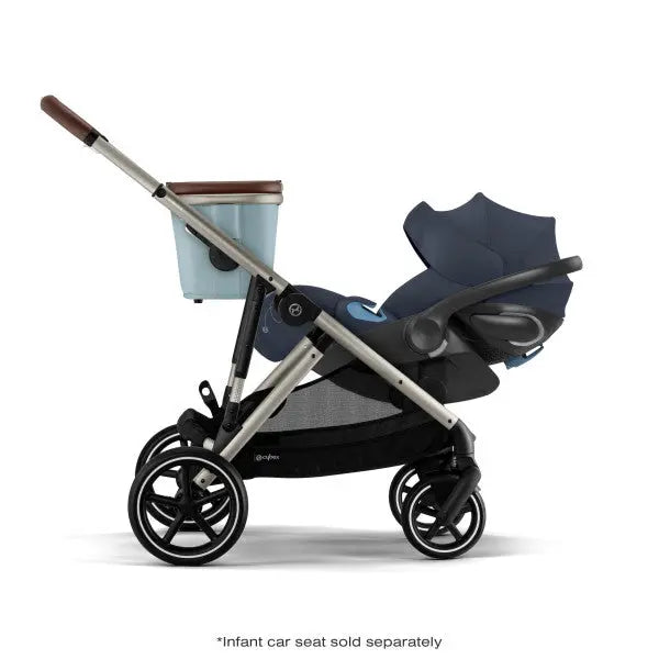 Close-up of the Cybex Gazelle S V2 Stroller in blue seat with aluminum frame and brown leather handlebar, ready to stroll.