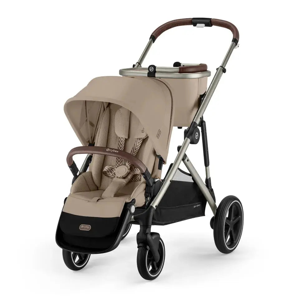 Close-up of the Cybex Gazelle S V2 Stroller in beige with brown handlebar; sturdy silver frame shown ready to push.
