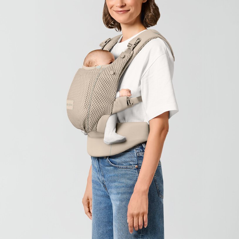CYBEX Gold Amya Baby Carrier in Almond Beige with newborn in front inward carry