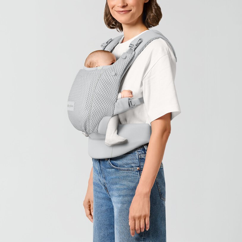 CYBEX Gold Amya Baby Carrier in Fog Grey with newborn in front inward carry