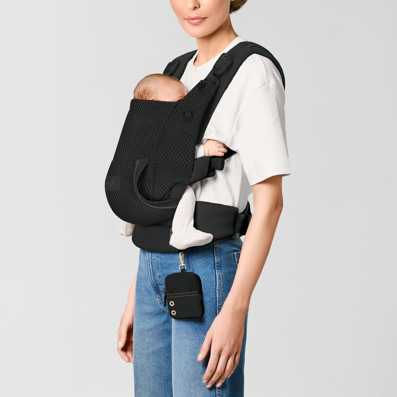 CYBEX Gold Laya Baby Carrier in Magic Black with newborn in front inward carry