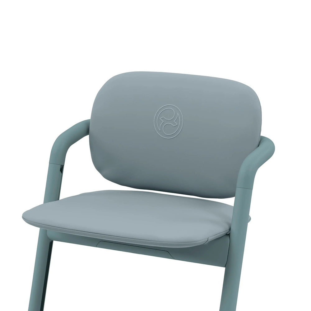 Lifestyle image of the Cybex Lemo 2 Comfort Inlay for high chair in soft blue, securely attached for cushioned baby comfort.