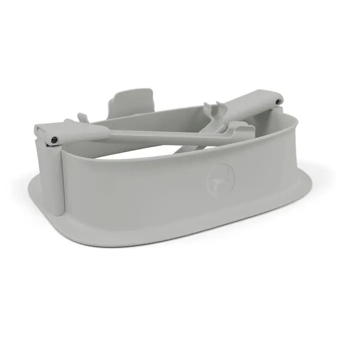 Lifestyle image of the Cybex Lemo Training Tower light gray plastic tabletop high chair with secure arms for toddler seating.