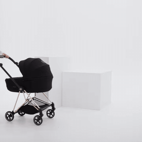CYBEX Mios 5 in Rose Gold and Sepia Black folding with the Fold Lux Carry Cot attached