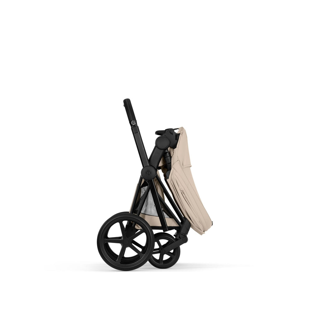 Cybex Platinum Priam 5 Luxury Stroller in light beige folded into a self-standing side profile.