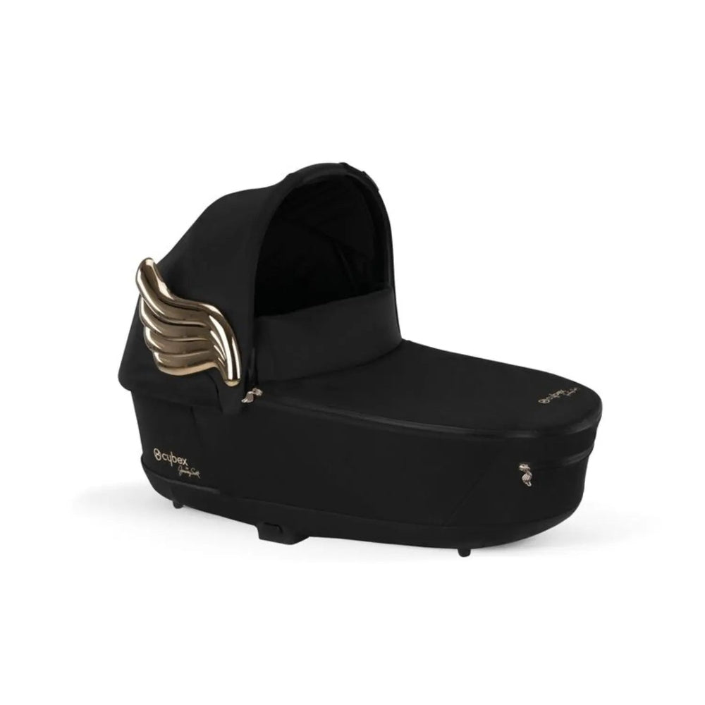 Lifestyle image of the Cybex Platinum Priam Carry Cot Limited Edition limited edition in black with gold wing accents, a sleek baby carry cot built for stroller use.