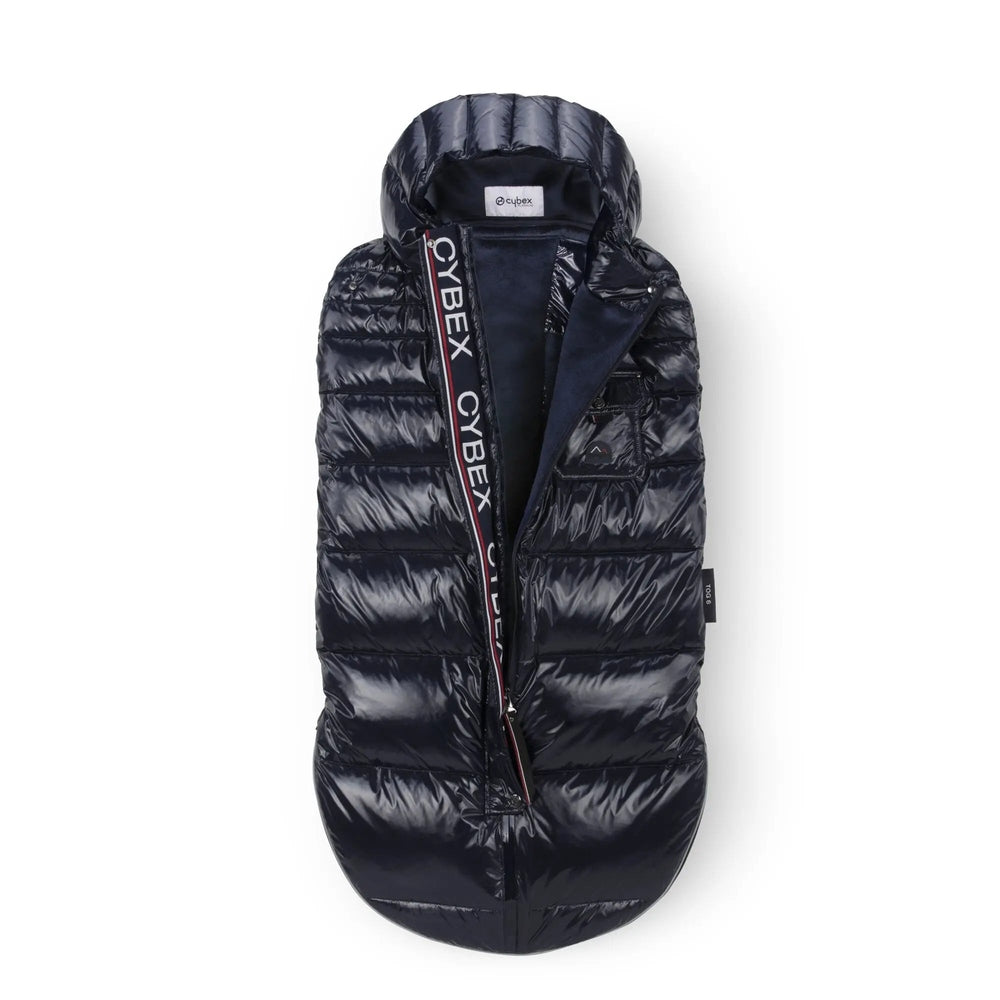 Close-up of the Cybex Winter Footmuff in navy quilted puffer with hood, unzipped to reveal navy lining on a stroller.
