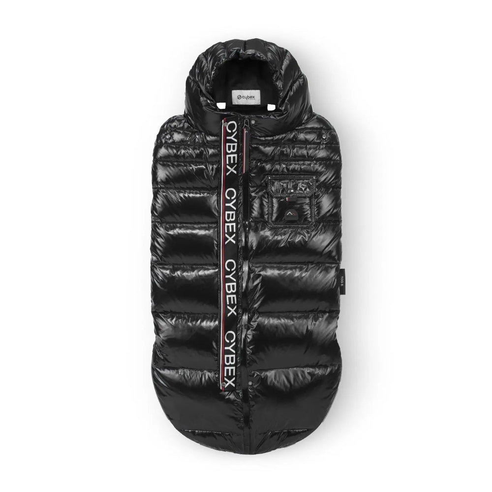 Close-up of the Cybex Winter Footmuff in black glossy puffer with hood, front pocket, and logo strap along the zipper.