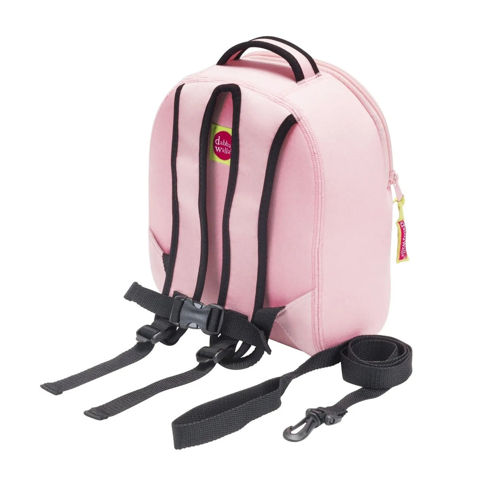 Dabbawalla Harness Backpack pink with black trim, showing adjustable twin shoulder straps and a detachable leash