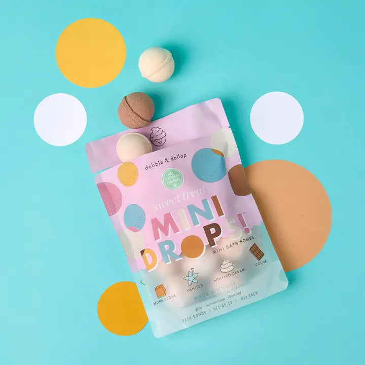Dabble & Dollop Mini Drops Bath Bombs in pastel pink packaging with multicolor bubble accents.