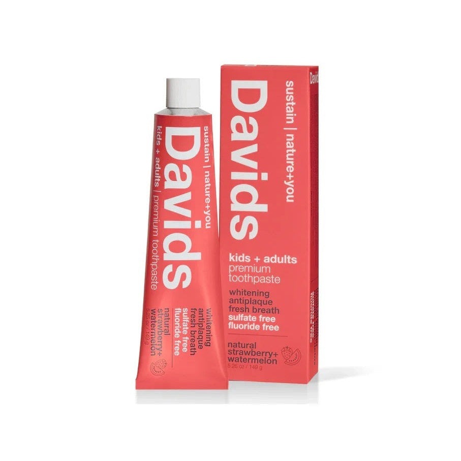 Davids fluoride-free strawberry watermelon toothpaste, tube standing beside its red box.