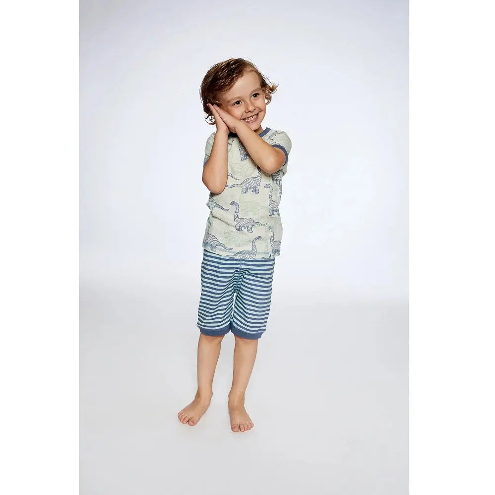 Deuxpardeux Organic Cotton Two Piece Short Pajama Set Heather Beige Printed Dinosaurs; child posing in striped shorts.