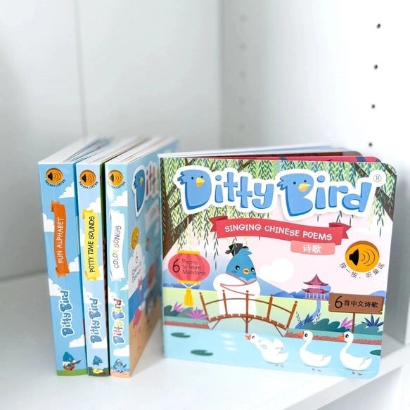 Ditty Bird Singing Chinese Poems USB-C Rechargeable toy set on shelf, colorful box plus four kiddie books visible.