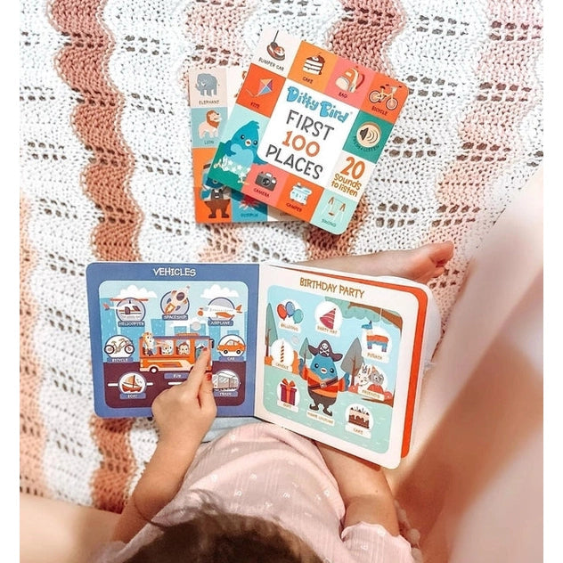 Ditty Bird Sound Book First 100 Words USB-C Rechargeable by DITTY BIRD; child taps colorful pages in a cozy reading scene.