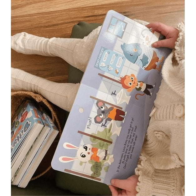 Ditty Bird Sound Book Funny Body Sounds being held by a child in a cream sweater, flipping colorful animal pages.