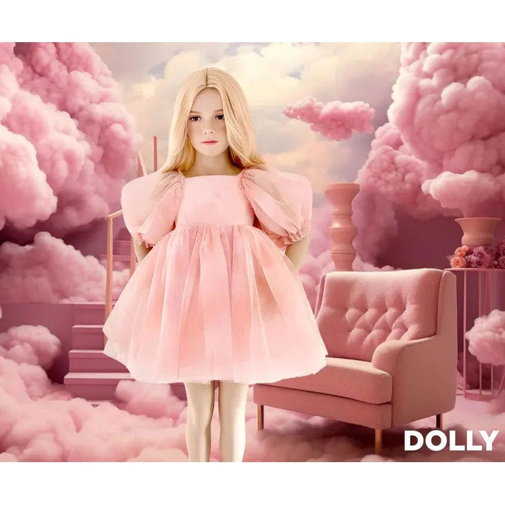 Dolly by Le Petit Dreamy Babydoll Puff Dress, pink tulle, doll standing in a pink cloud backdrop.