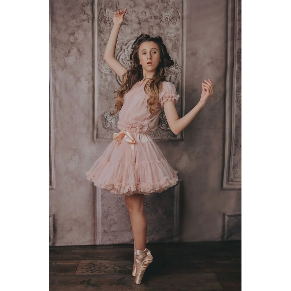 Dolly By Le Petit Tom Pettiskirt Dorothy In The Land Of Dolls Ballet Pink girl en pointe in a soft pink ruffled tulle skirt.