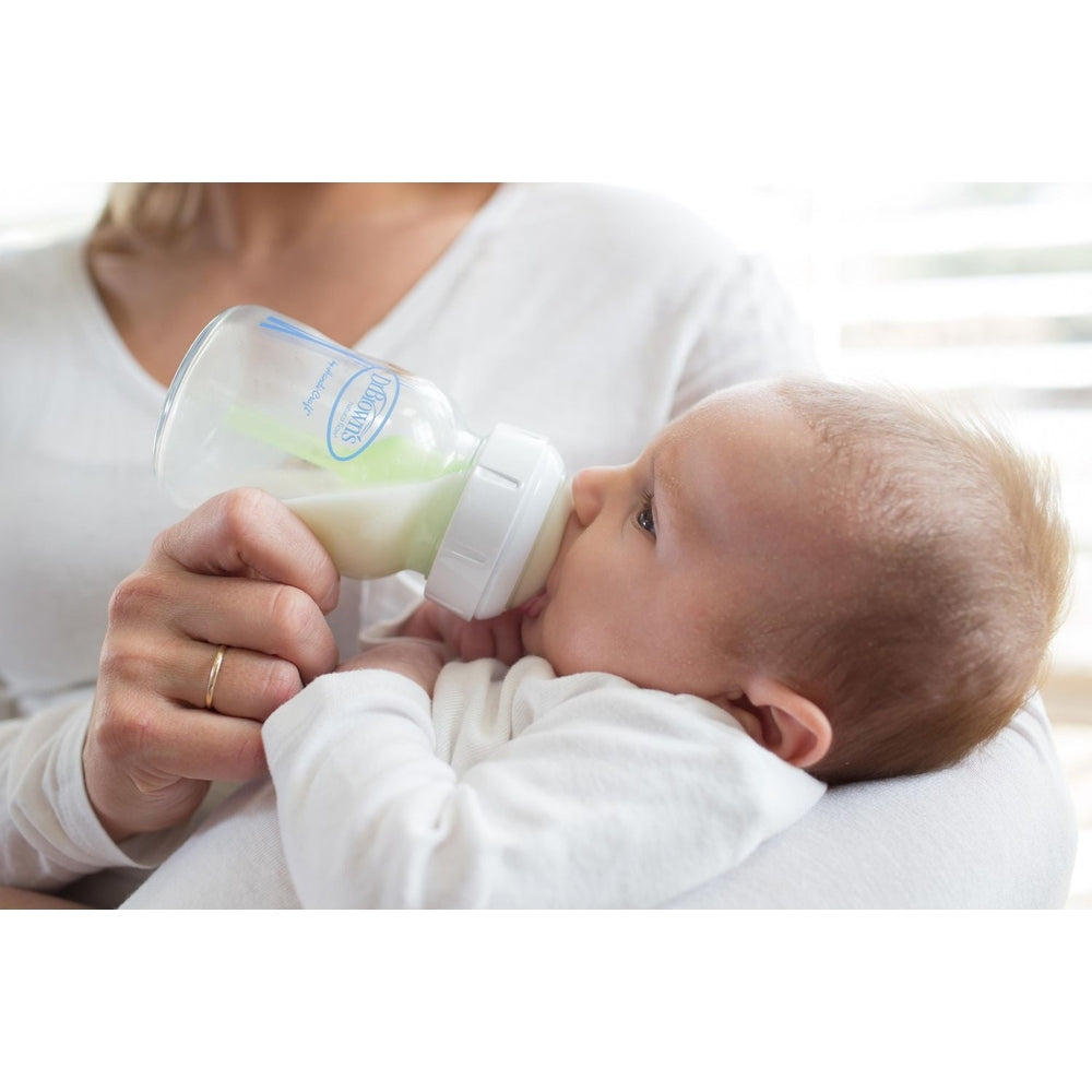 Dr. Brown's Natural Flow Options+ Silicone Wide-Neck Nipple 2-Pack in clear baby bottle with white cap during feeding.