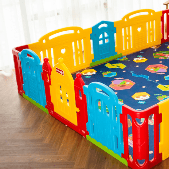 Dwinguler Castle Extension Set Rainbow play yard with bright blue, yellow and red panels forming an enclosed play area.