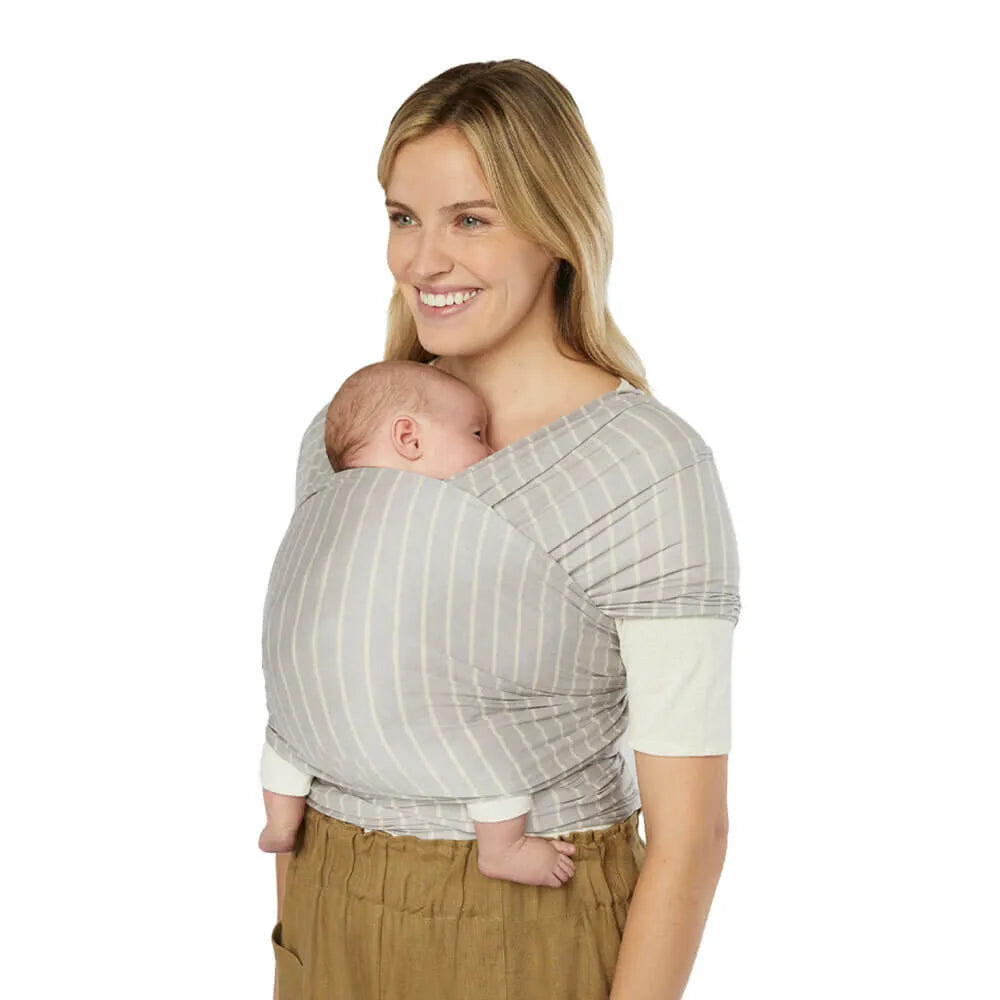 Ergobaby Aura baby wrap in gray striped sustainable knit, cradling a newborn against mom