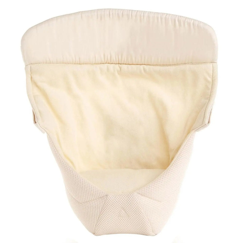 Ergobaby Easy Snug Infant Insert in cream; plush padded interior shown inside a baby carrier for newborn support.