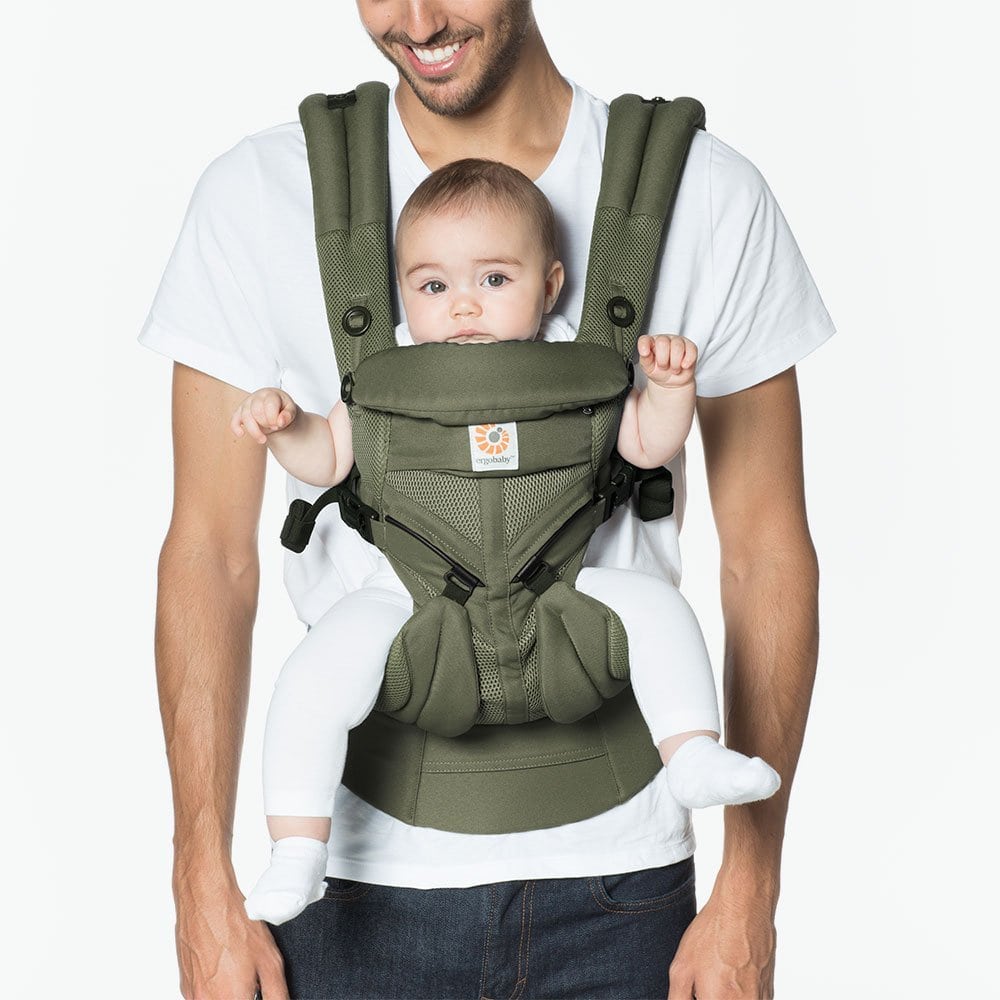 ERGOBABY Omni 360 Cool Air Mesh baby carrier in olive green worn by a parent with a baby, featuring padded straps.