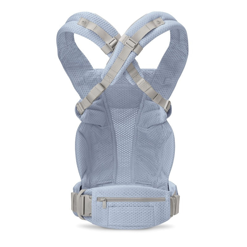 Ergobaby Omni Deluxe Carrier Mesh in light blue mesh worn by adult, with cross-back padded straps and secure waist belt.