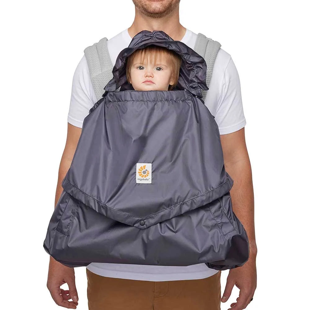 Front view of a parent and baby wearing the charcoal Ergobaby Rain and Wind Carrier Cover.