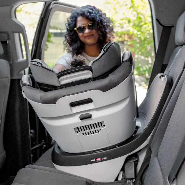 Evenflo Revolve360 Slim 2-in-1 rotational car seat with SensorSafe installed in car rear seat