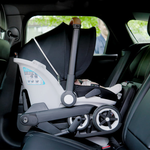 Evenflo Gold Shyft Dualride infant car seat and Carryall stroller in car interior, black canopy with gray frame