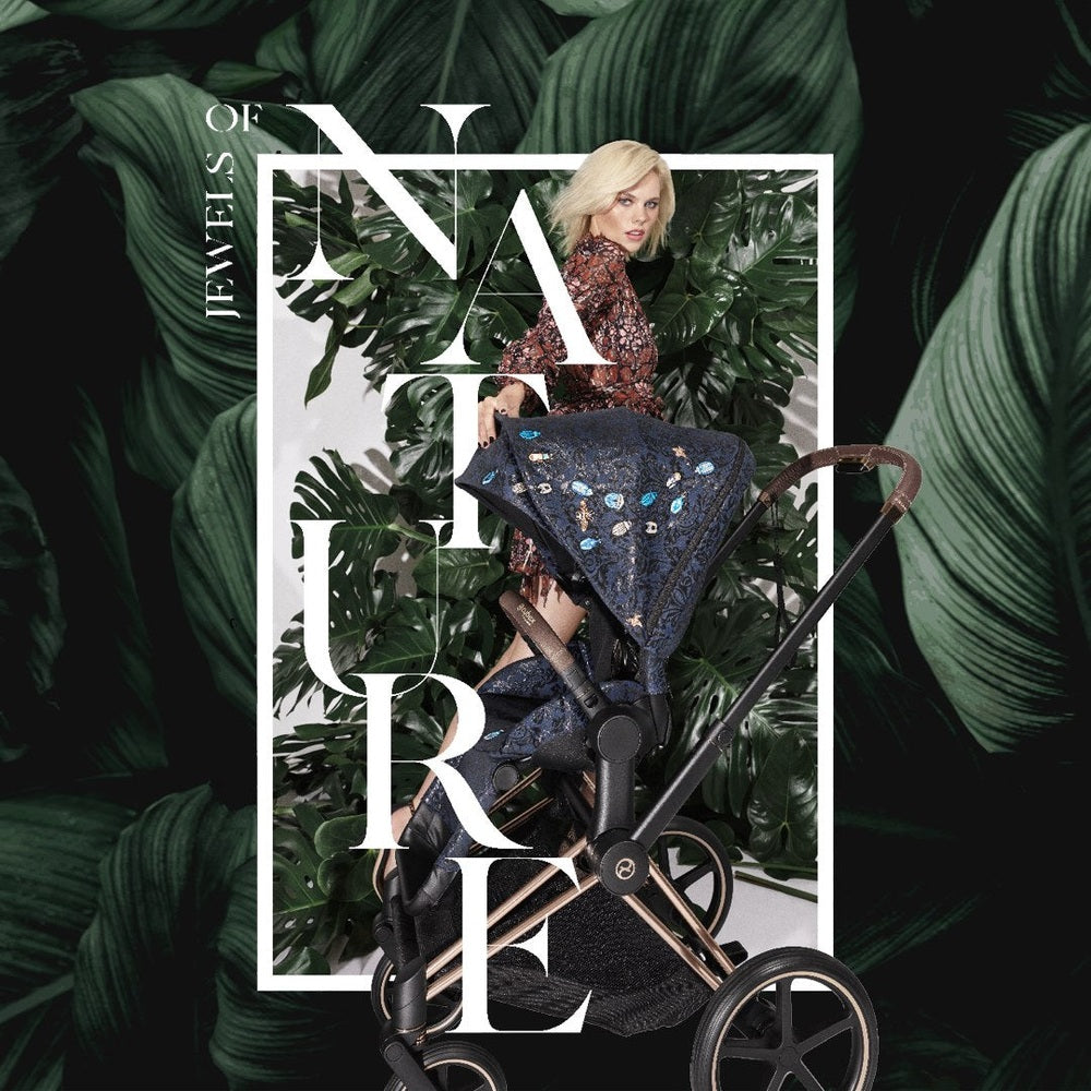 Fashion campaign image of the Cybex Platinum Priam 4 Luxury Stroller Limited Edition Jewels of Nature with a model against oversized botanical leaves.