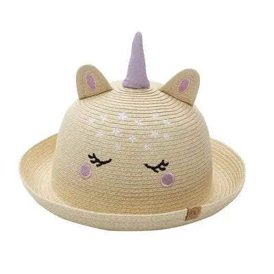 Flapjackkids Kids Straw Hat Unicorn sits flat, beige straw with purple horn and ears, sun-safe.