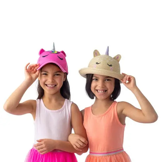 Flapjackkids Kids Straw Hat Unicorn; two smiling girls adjust pink unicorn cap and beige straw hat with ears.