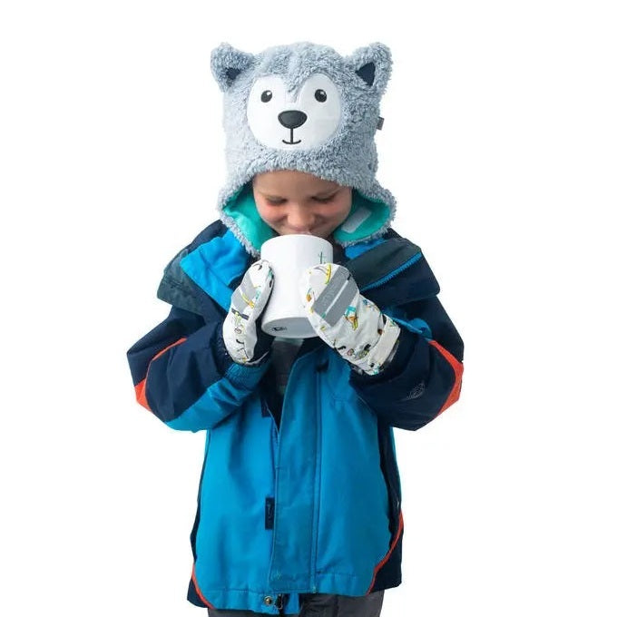 Flapjackkids Reversible Kids Sherpa Hat Wolf & Ski Goggles on a kid in a blue jacket, sipping from a mug.