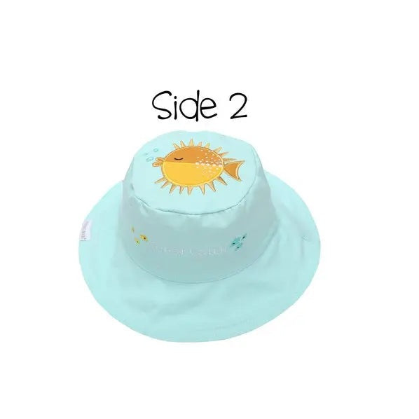 Flapjackkids Reversible Kids Sun Hat Fish & Jellyfish in turquoise, laid flat with cheerful sun embroidery on crown.