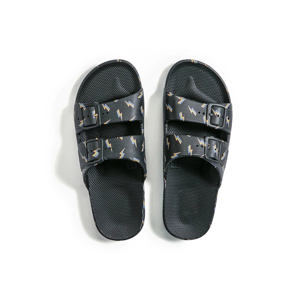 Freedom Moses Prints Adult Bolt Black sandals with two adjustable buckles and bolt-pattern straps.