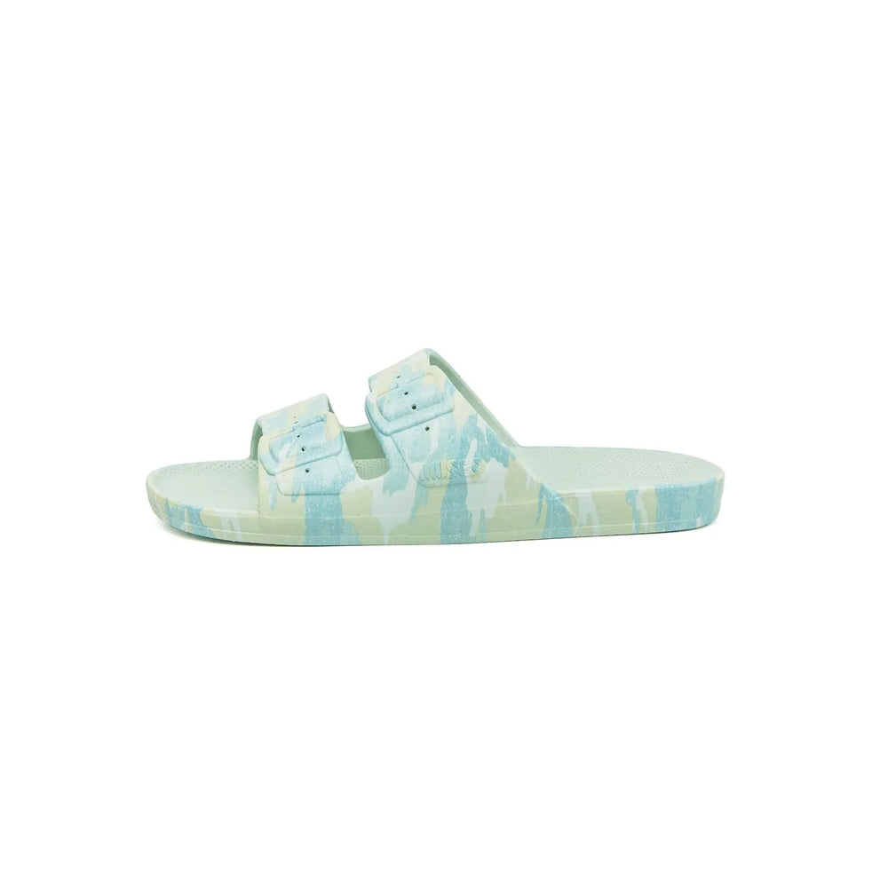 Freedom Moses Prints Camo Sage slides with two adjustable straps resting on a pastel camo footbed