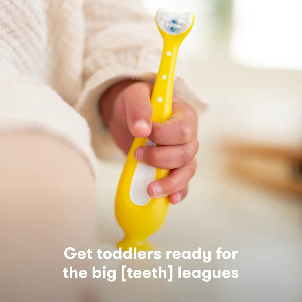Frida Baby Training Toothbrush for Toddlers 18M+ with yellow easy-grip handle