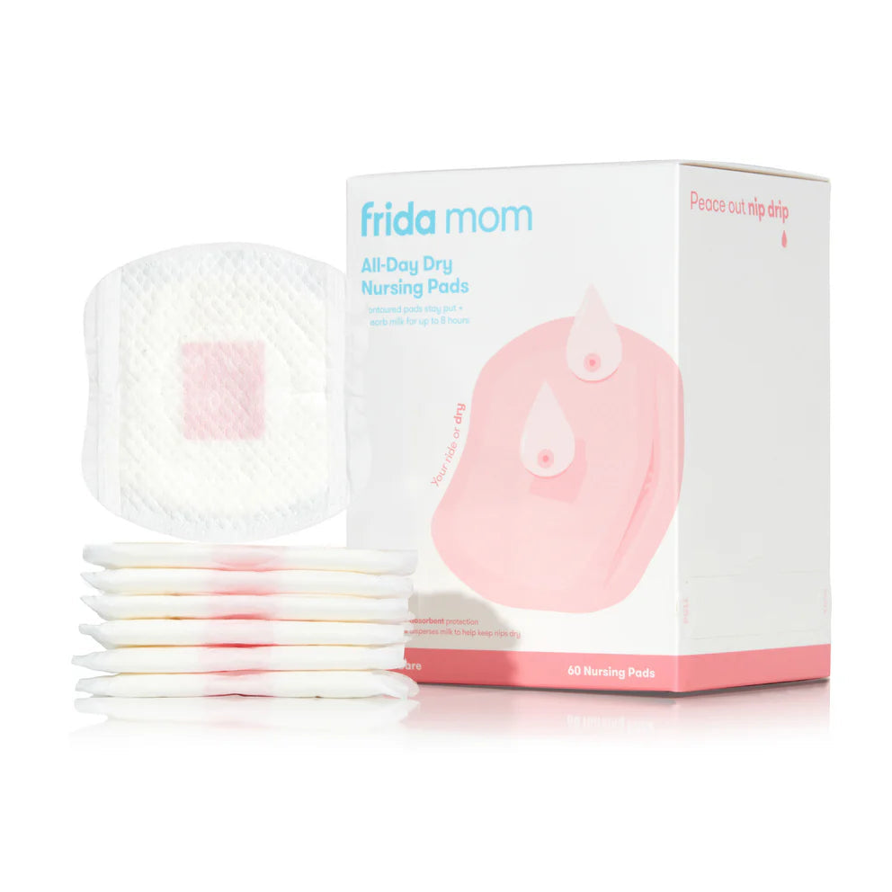 Frida Mom All-Day Dry Nursing Pads, white disposable pads with pink center, 60-count box.