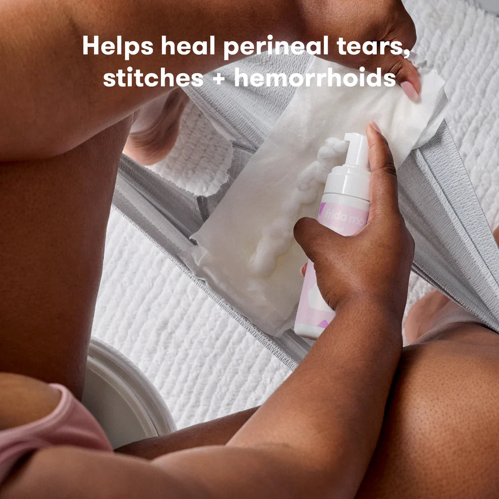 Frida Mom Witch Hazel Perineal Healing Foam pink bottle for postpartum perineal care by FRIDA