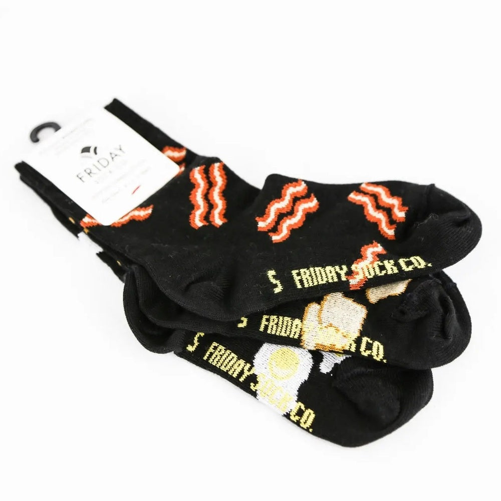 Friday Sock Co. Kid's Socks Bacon, Egg & Toast: three black pairs laid out to show bacon, egg and toast motifs.