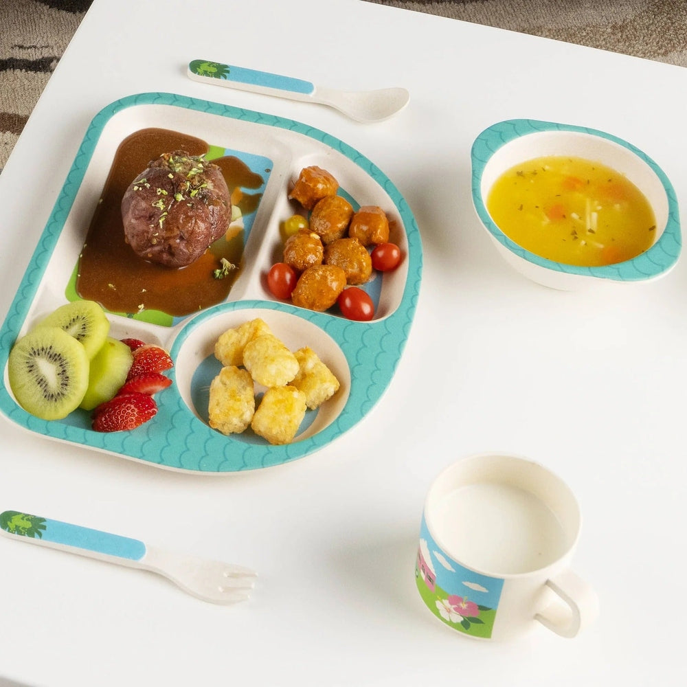 Five-piece bamboo children's dining set with turquoise wave-pattern tray, divided plate, bowl, spoon, and tropical mug.
