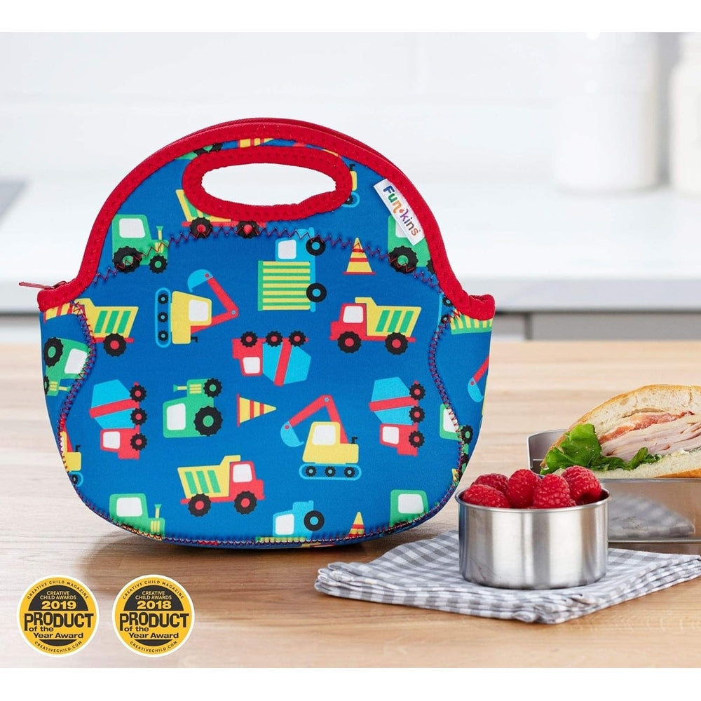 Blue insulated lunch bag with red trim and construction-vehicles pattern, top handle.