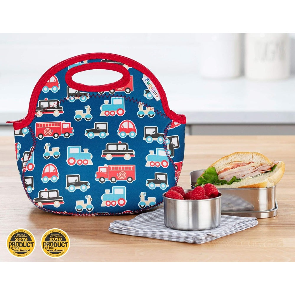 Blue insulated lunch bag with red trim and vehicle print; toddler-friendly handle, beside sandwich and raspberries.
