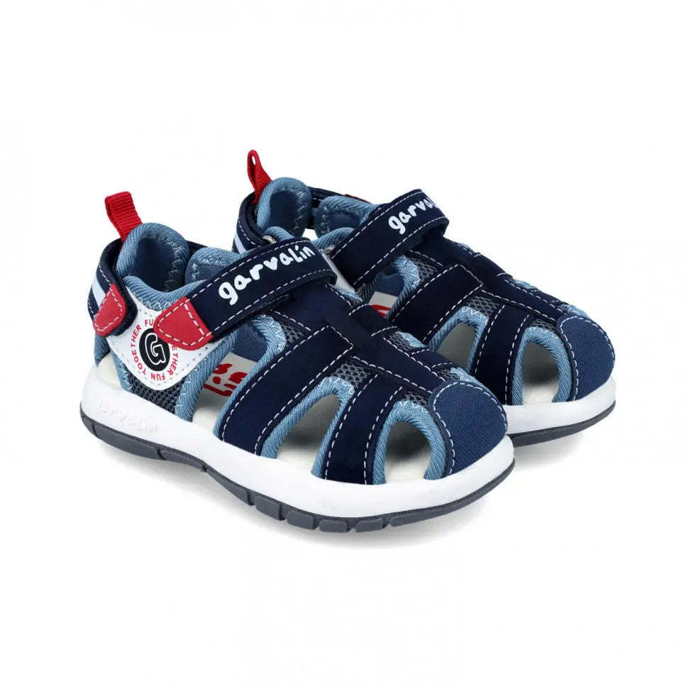 Garvalin Children Sandals Navy Blue; twin navy sandals with red pull tabs and Velcro straps, white cushioned sole