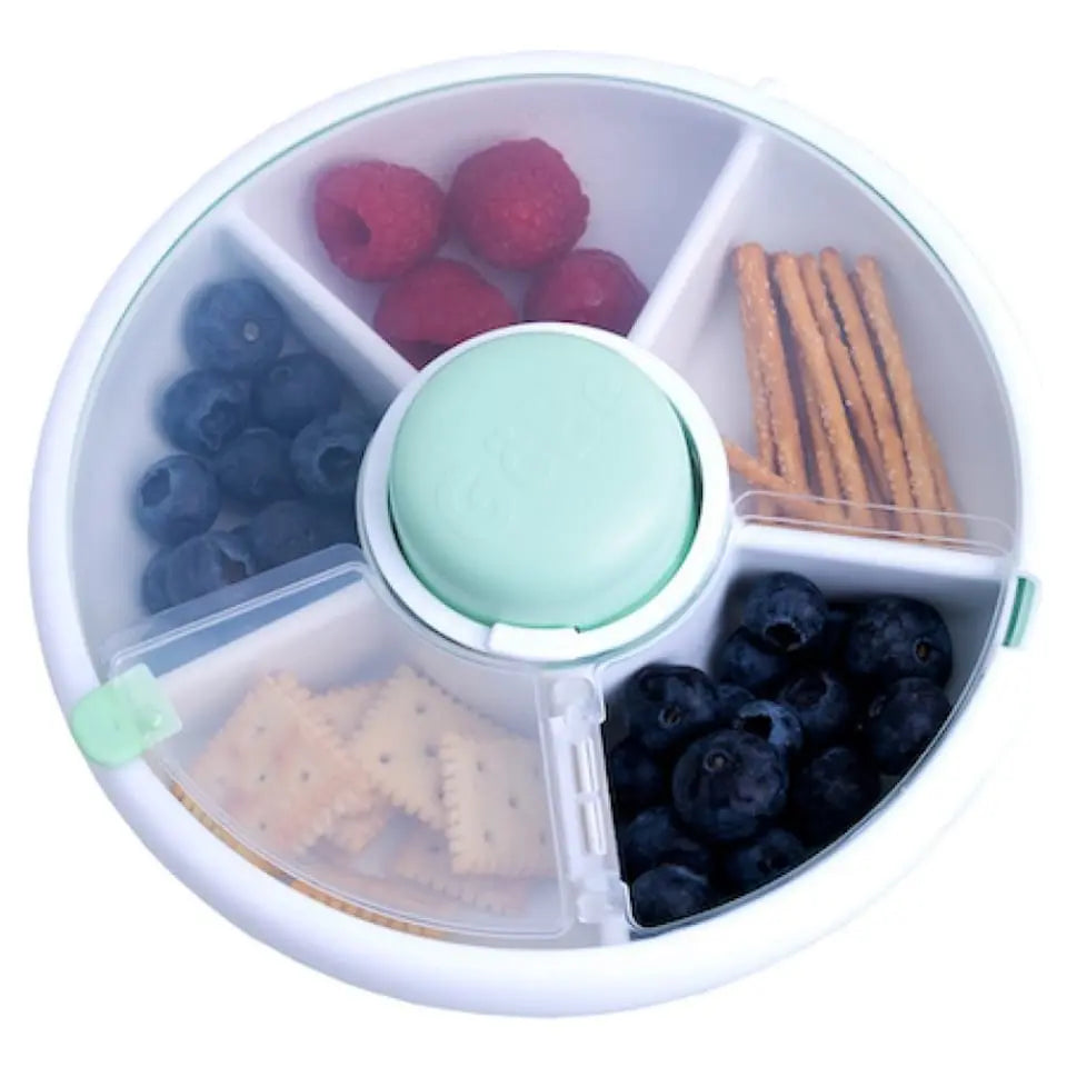 Gobe Snack Spinner Small round lunch box with mint lid, showing blueberries, raspberries, crackers, and pretzels.