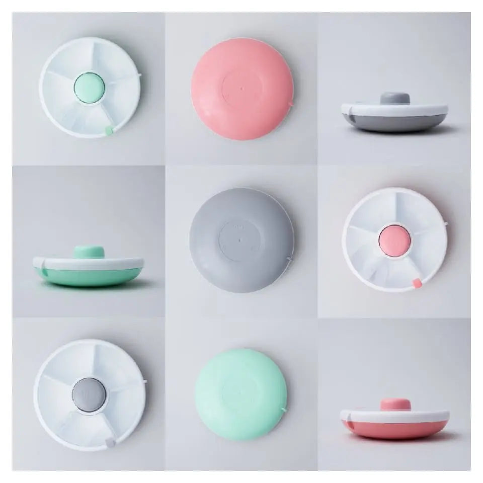 Gobe Snack Spinner Small pastel snack containers in mint, pink and gray; shown with lids snapped shut and stacked.