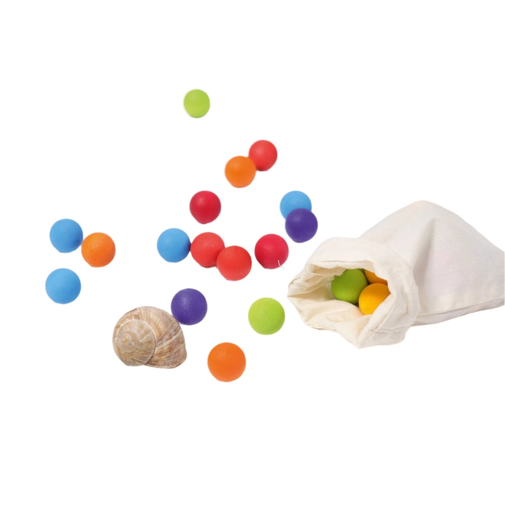 Grimm's 35pc multicoloured wooden marbles spilling from a cloth bag