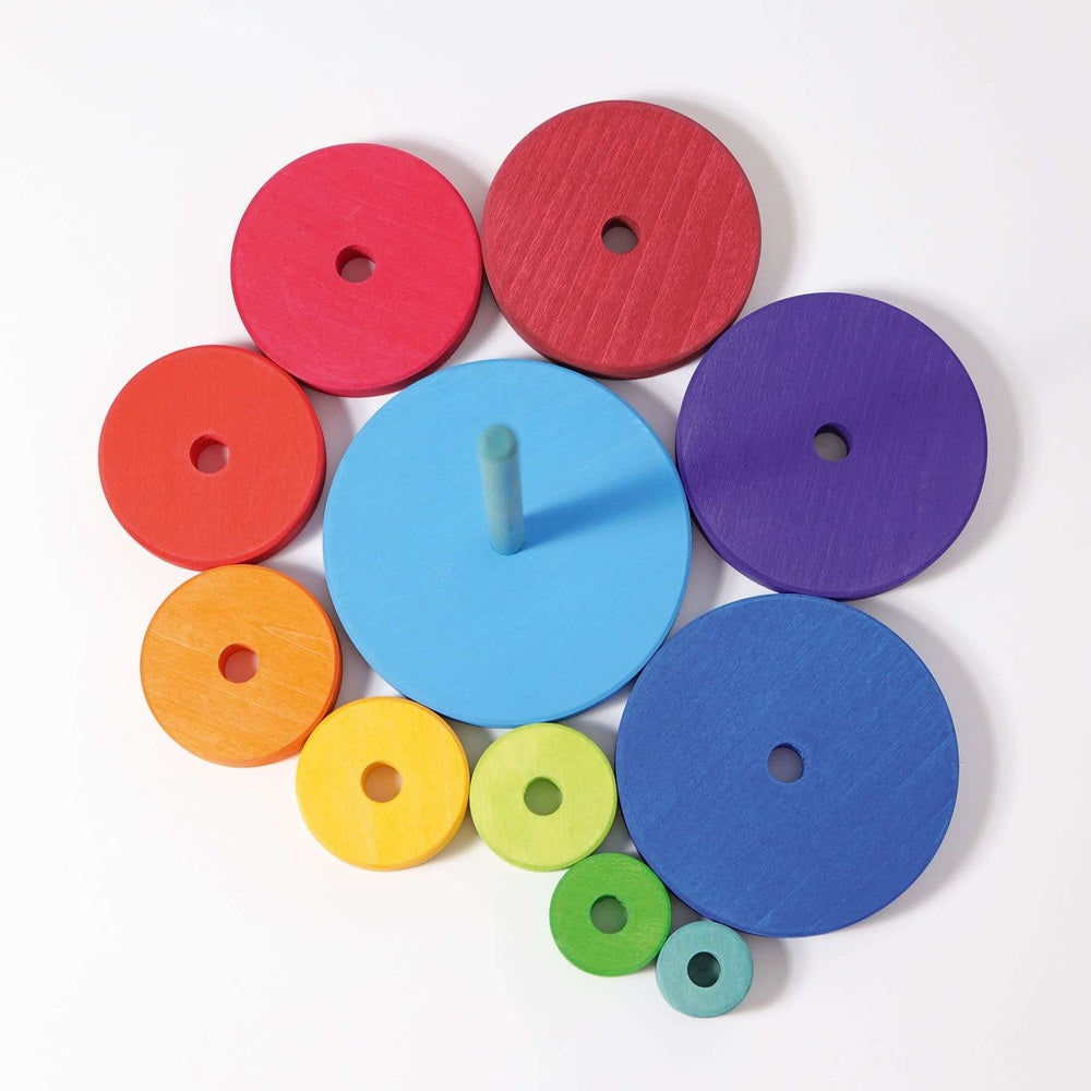 Grimm's Stacking Conical Tower Large with colorful wooden discs on a blue central rod