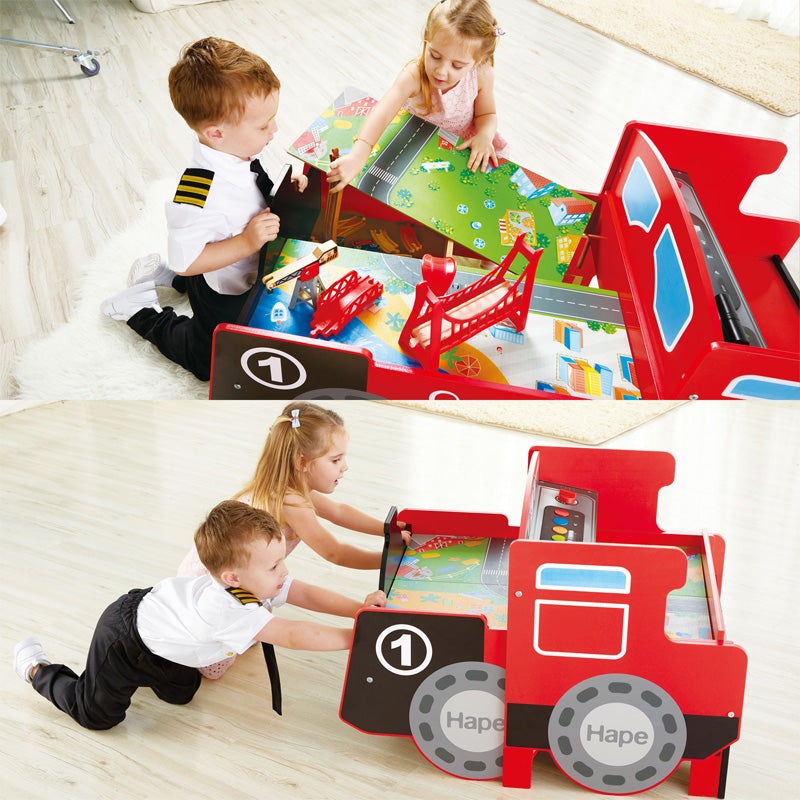 Hape Ride-On Engine Table red play set with gray wheels and colorful map; two kids playing.